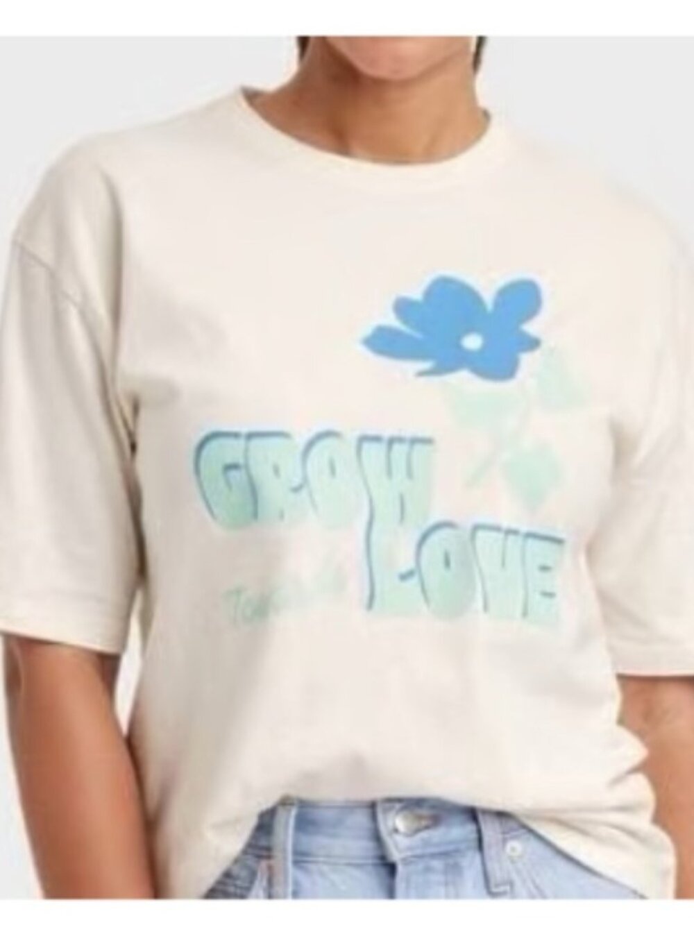 Tan & blue "Grow Love" graphic tee with blue flower and 'GROW LOVE'